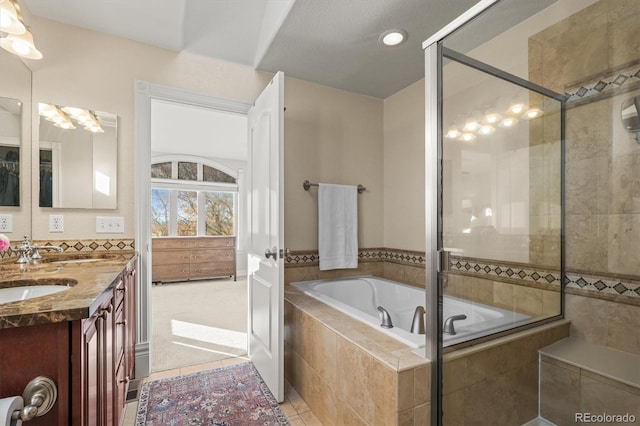 bathroom with plus walk in shower, tile patterned floors, and vanity