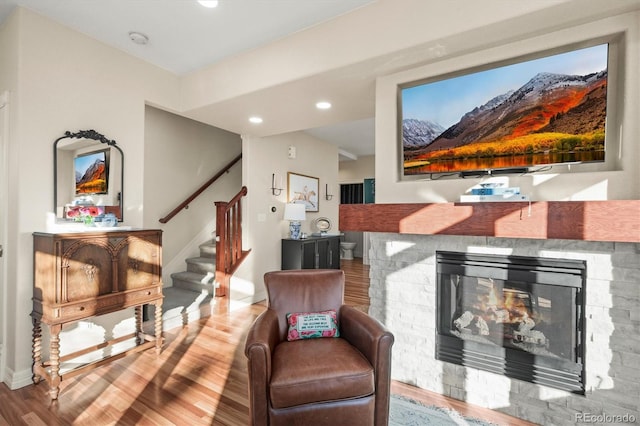 2801 W 23rd Ave, Denver, CO 80211 - living room featuring recessed lighting, baseboards, a stone fireplace, stairs, and wood finished floors