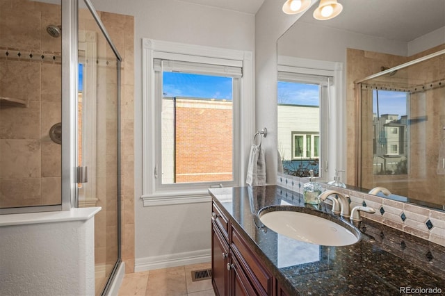 2801 W 23rd Ave, Denver, CO 80211 - full bath featuring a stall shower, baseboards, visible vents, tile patterned flooring, and vanity