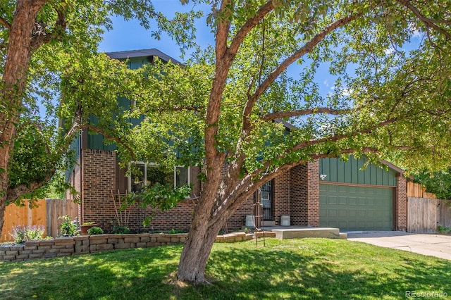 9400 W Burgundy Ave, Littleton, CO 80123 - view of front of home with brick siding, driveway, and board and batten siding