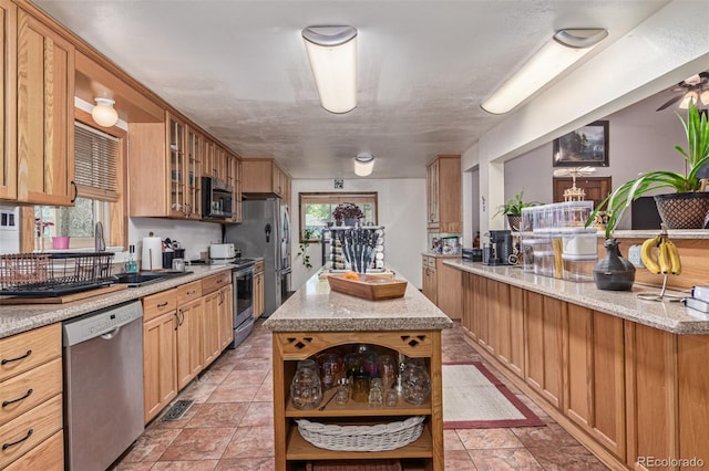 9400 W Burgundy Ave, Littleton, CO 80123 - kitchen with stainless steel appliances, open shelves, glass insert cabinets, light stone countertops, and a kitchen island