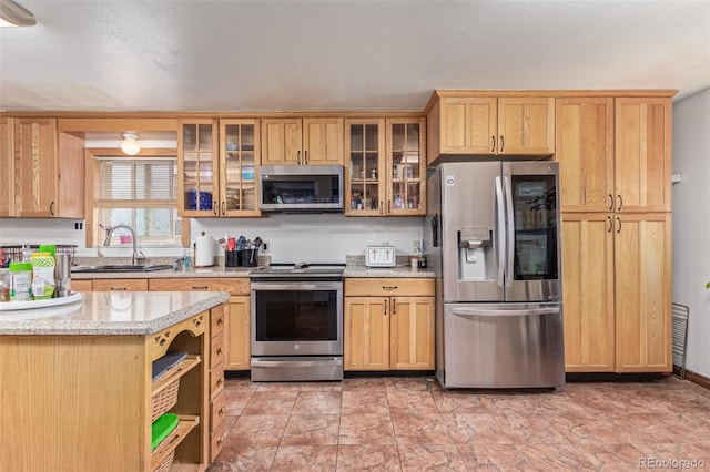 9400 W Burgundy Ave, Littleton, CO 80123 - kitchen featuring stainless steel appliances, open shelves, light stone counters, glass insert cabinets, and light brown cabinets