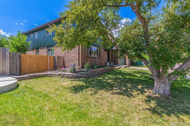 9400 W Burgundy Ave, Littleton, CO 80123 - view of front of property featuring brick siding, board and batten siding, and an attached garage