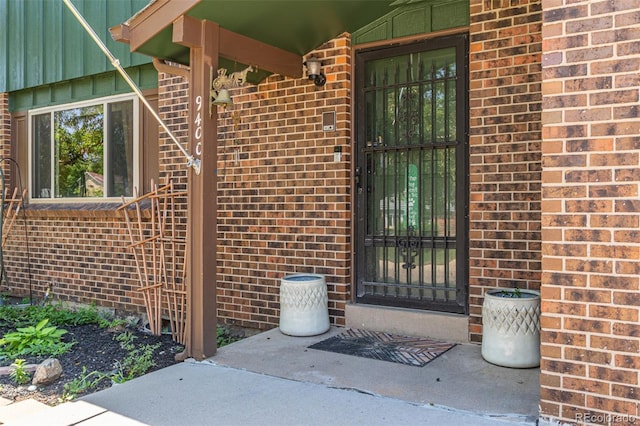 9400 W Burgundy Ave, Littleton, CO 80123 - view of exterior entry featuring brick siding and board and batten siding