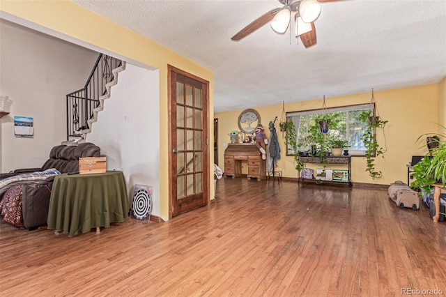 9400 W Burgundy Ave, Littleton, CO 80123 - living area with wood-type flooring, ceiling fan, a textured ceiling, and stairs