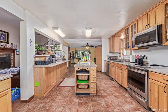9400 W Burgundy Ave, Littleton, CO 80123 - kitchen with stainless steel appliances, ceiling fan, glass insert cabinets, and healthy amount of natural light