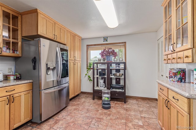 9400 W Burgundy Ave, Littleton, CO 80123 - kitchen with stainless steel fridge with ice dispenser, glass insert cabinets, and light stone countertops