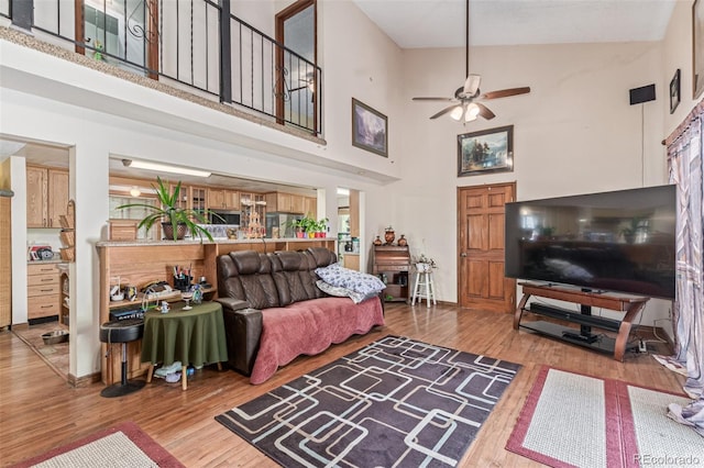 9400 W Burgundy Ave, Littleton, CO 80123 - living room featuring a towering ceiling, ceiling fan, and wood finished floors