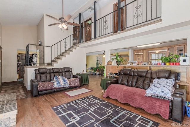 9400 W Burgundy Ave, Littleton, CO 80123 - living area featuring ceiling fan, a high ceiling, stairs, and wood finished floors