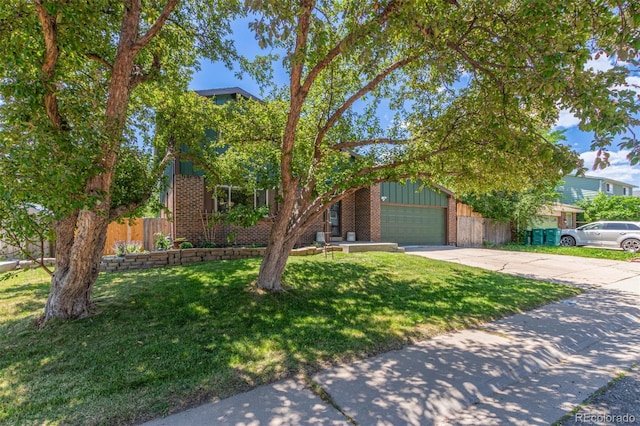 9400 W Burgundy Ave, Littleton, CO 80123 - obstructed view of property with a garage, concrete driveway, and brick siding