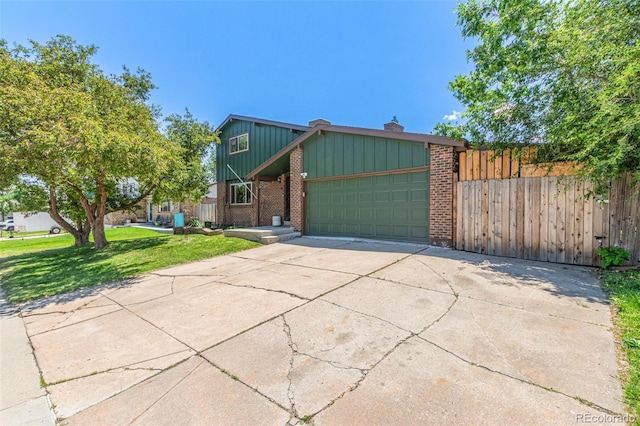 9400 W Burgundy Ave, Littleton, CO 80123 - view of property exterior featuring an attached garage, brick siding, driveway, and board and batten siding