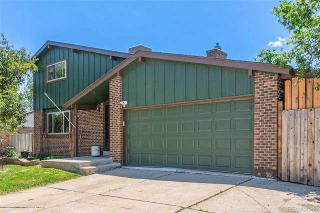 9400 W Burgundy Ave, Littleton, CO 80123 - view of front of house with board and batten siding, brick siding, and a garage