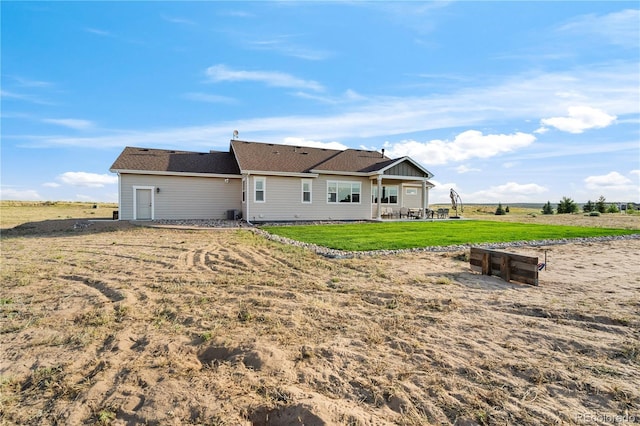 rear view of property featuring a yard and a patio