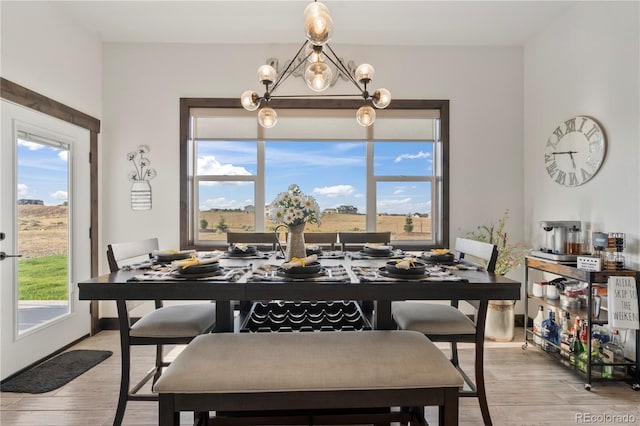 dining space featuring a notable chandelier and light wood finished floors