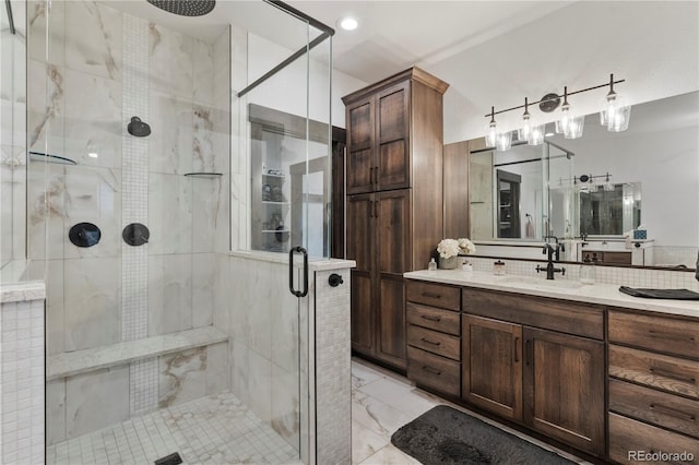 bathroom featuring a stall shower, marble finish floor, and vanity