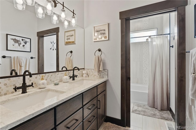 bathroom featuring double vanity, shower / bathtub combination with curtain, backsplash, and a sink