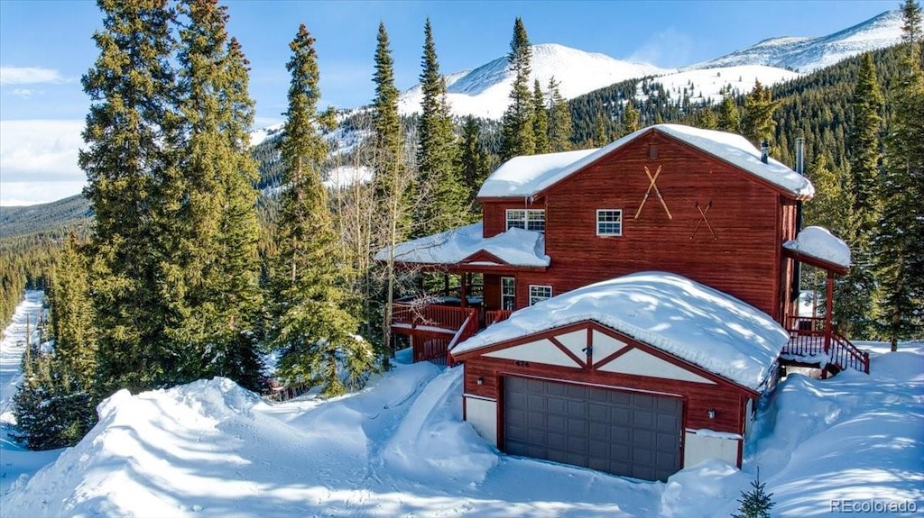 exterior space with a garage, an outdoor structure, and a mountain view