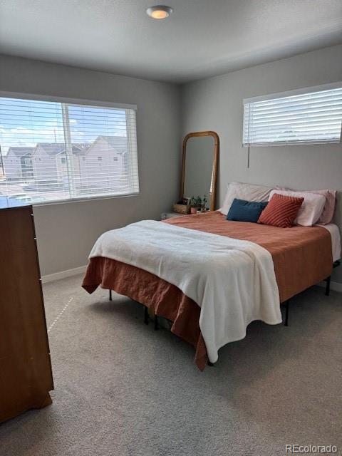 1353 Reynolds St Unit 5A, Fort Lupton, CO 80621 - bedroom featuring light carpet and baseboards