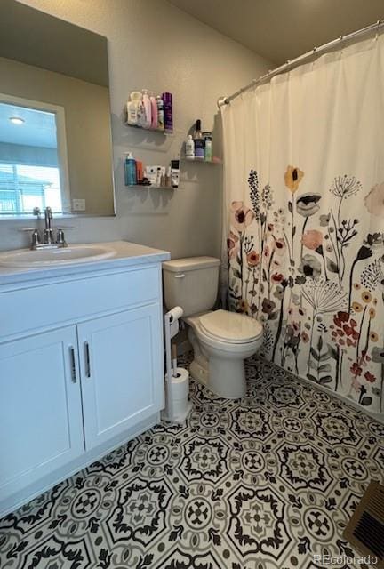 1353 Reynolds St Unit 5A, Fort Lupton, CO 80621 - bathroom with toilet, vanity, tile patterned floors, a shower with shower curtain, and vaulted ceiling