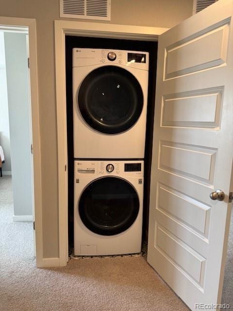 1353 Reynolds St Unit 5A, Fort Lupton, CO 80621 - washroom featuring stacked washer / dryer, carpet, and baseboards