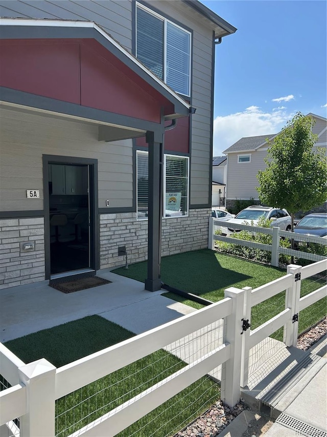 1353 Reynolds St Unit 5A, Fort Lupton, CO 80621 - property entrance featuring stone siding
