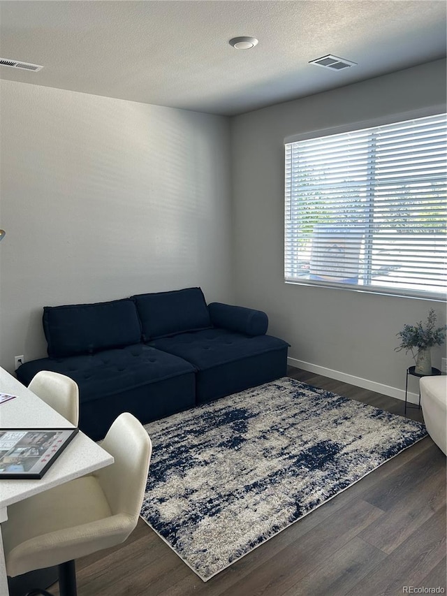 1353 Reynolds St Unit 5A, Fort Lupton, CO 80621 - living room featuring wood finished floors and a textured ceiling