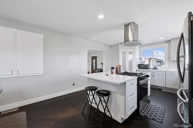 15528 Nancy Ave, Fort Lupton, CO 80621 - kitchen with island exhaust hood, stainless steel appliances, a kitchen bar, a kitchen island, and dark wood-style floors