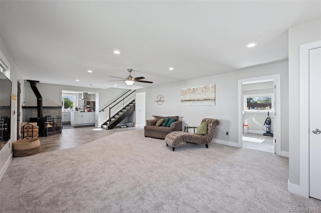 15528 Nancy Ave, Fort Lupton, CO 80621 - living room featuring carpet flooring, a wood stove, healthy amount of natural light, and recessed lighting