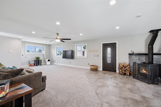 15528 Nancy Ave, Fort Lupton, CO 80621 - living area with recessed lighting, a ceiling fan, and a wood stove