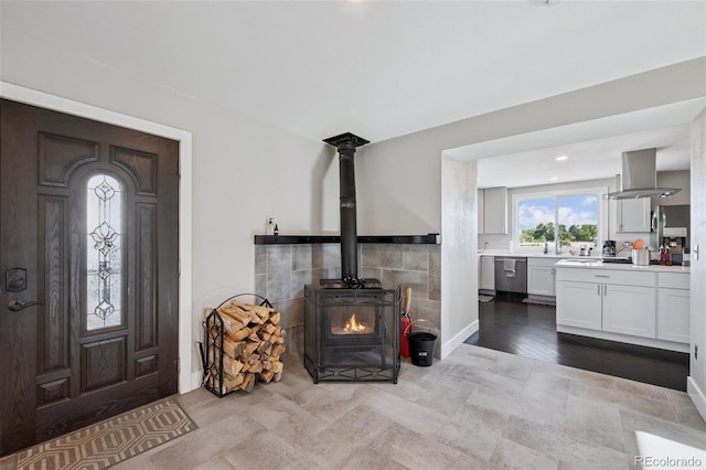 15528 Nancy Ave, Fort Lupton, CO 80621 - entrance foyer featuring a wood stove