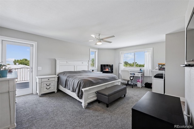 15528 Nancy Ave, Fort Lupton, CO 80621 - carpeted bedroom featuring access to exterior, ceiling fan, and a glass covered fireplace