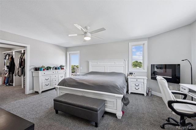 15528 Nancy Ave, Fort Lupton, CO 80621 - bedroom featuring dark colored carpet, a spacious closet, a ceiling fan, and an office area