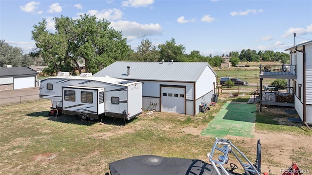 15528 Nancy Ave, Fort Lupton, CO 80621 - rear view of house with a detached garage, an outdoor structure, and a metal roof