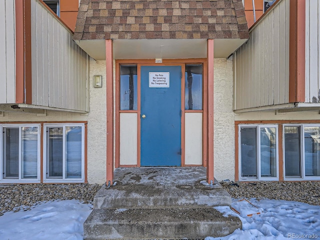 view of snow covered property entrance