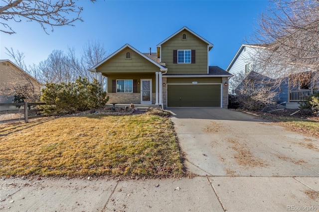 traditional-style house featuring a garage, brick siding, fence, driveway, and a front lawn