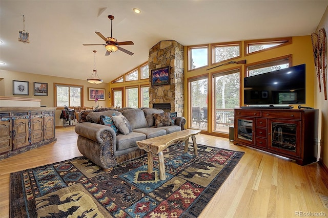 199 Elk Horn Ct, Bailey, CO 80421 - living room with a fireplace, wood finished floors, ceiling fan, and high vaulted ceiling