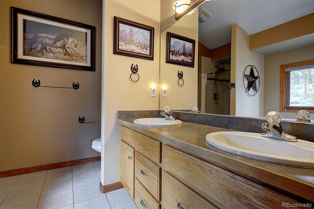 199 Elk Horn Ct, Bailey, CO 80421 - bathroom with double vanity, a stall shower, toilet, tile patterned flooring, and baseboards