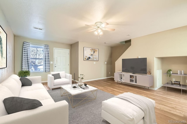 living room with ceiling fan and wood-type flooring