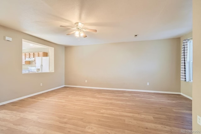 unfurnished room with light hardwood / wood-style flooring and ceiling fan