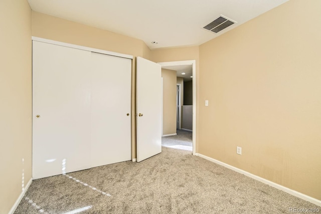 unfurnished bedroom featuring carpet flooring and a closet