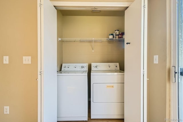 clothes washing area featuring washer and dryer