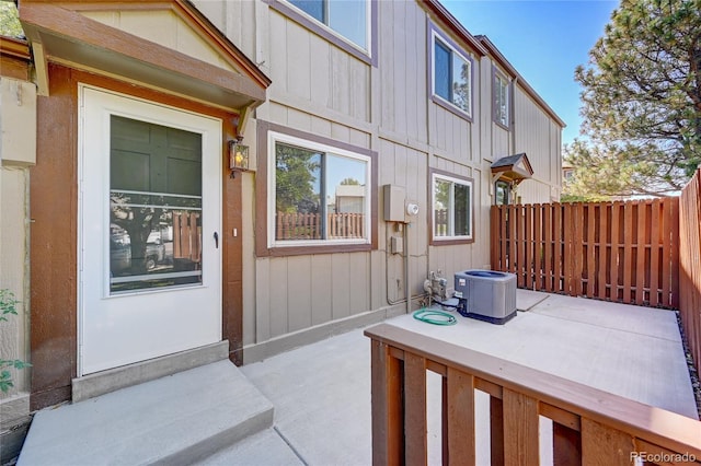 7700 W Glasgow Pl Unit 1A, Littleton, CO 80128 - doorway to property with board and batten siding and a patio