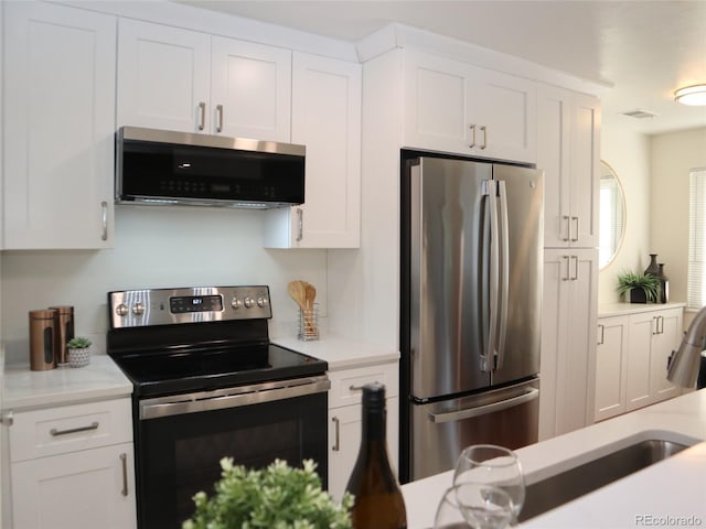 7700 W Glasgow Pl Unit 1A, Littleton, CO 80128 - kitchen with stainless steel appliances, light countertops, and white cabinets