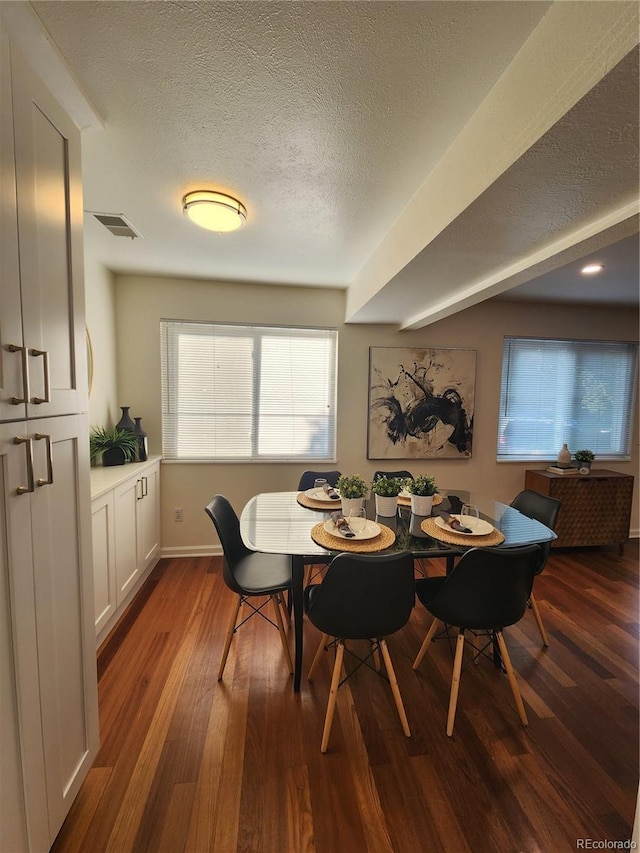 7700 W Glasgow Pl Unit 1A, Littleton, CO 80128 - dining room featuring dark wood-type flooring and a textured ceiling