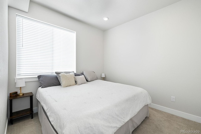 carpeted bedroom with multiple windows