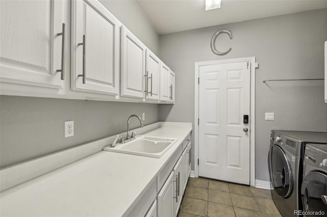 laundry room featuring washer and clothes dryer, cabinet space, tile patterned flooring, and baseboards