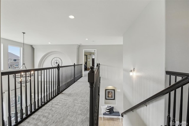 hallway featuring a chandelier, recessed lighting, and carpet