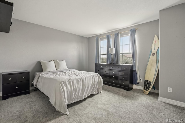 bedroom with carpet flooring and baseboards