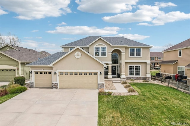 view of front of property with stone siding, stucco siding, driveway, a garage, and roof with shingles