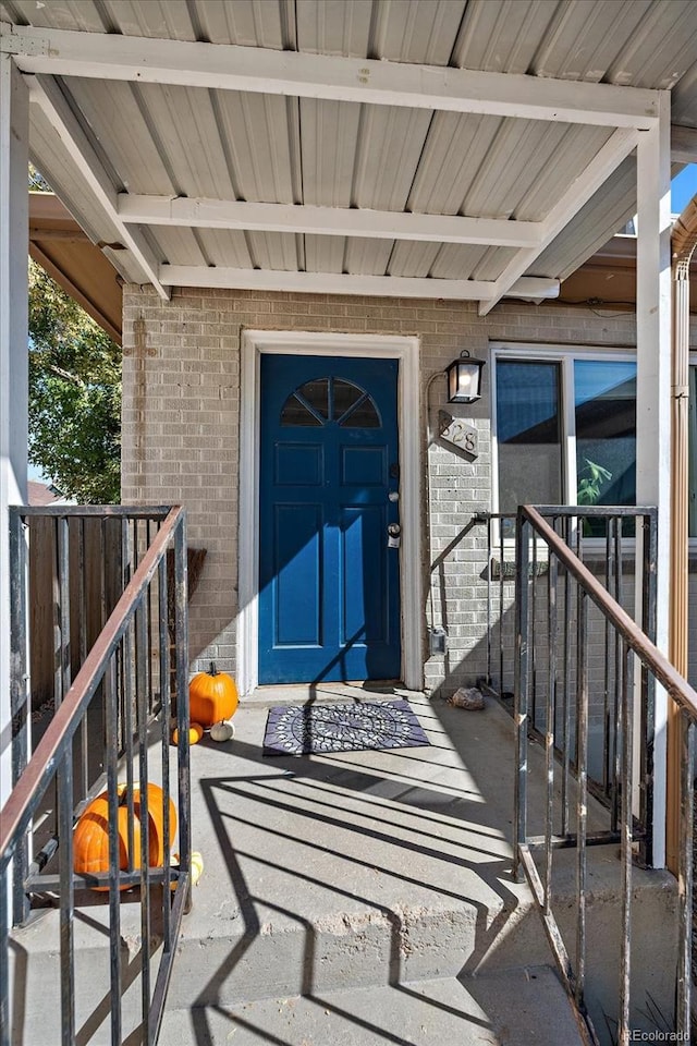 doorway to property with brick siding